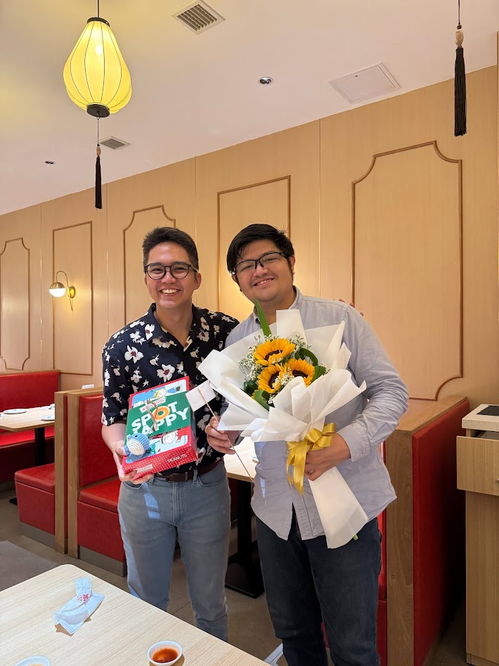 Harvey and Ken with the sunflower bouquet on the last day of Harvey's class